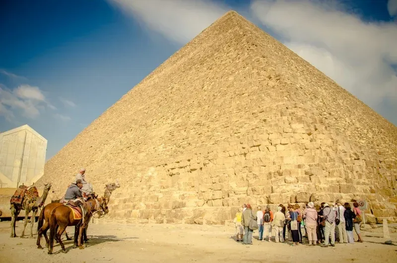 Horse silhouette Giza Pyramids sunset — private Cairo desert horse ride